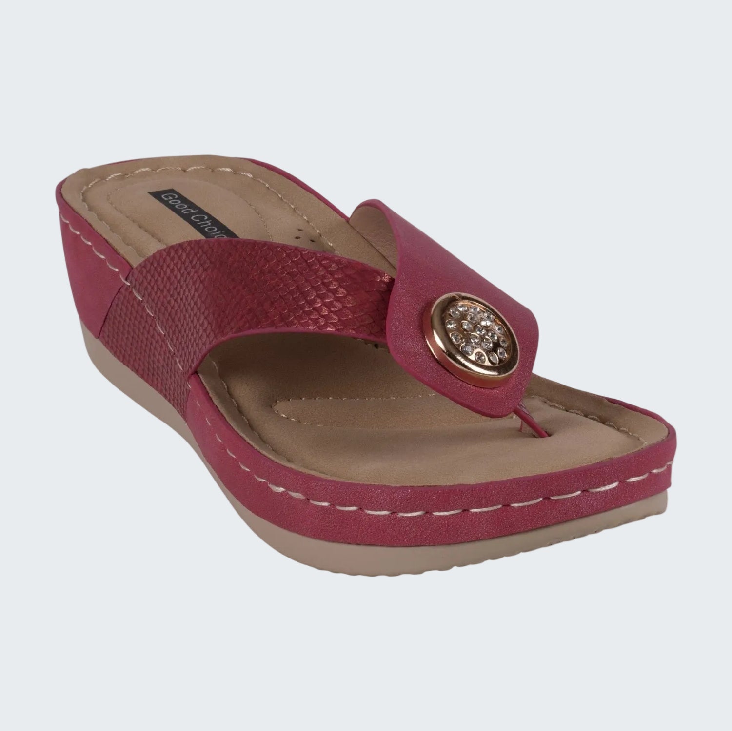 Red sandal with a decorative button on a white background
