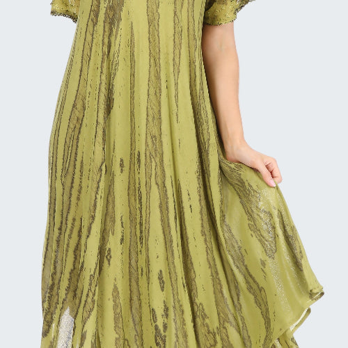 Green patterned dress worn by a model on a white background