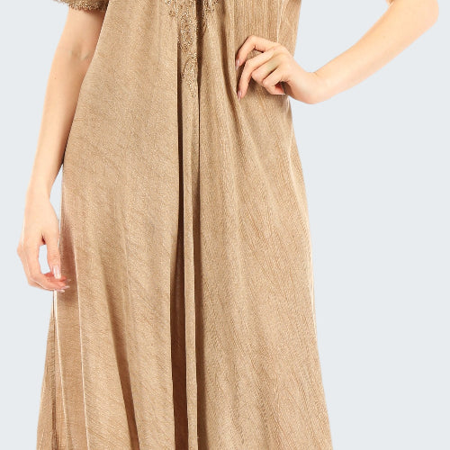 Beige lace dress worn by a model on a white background