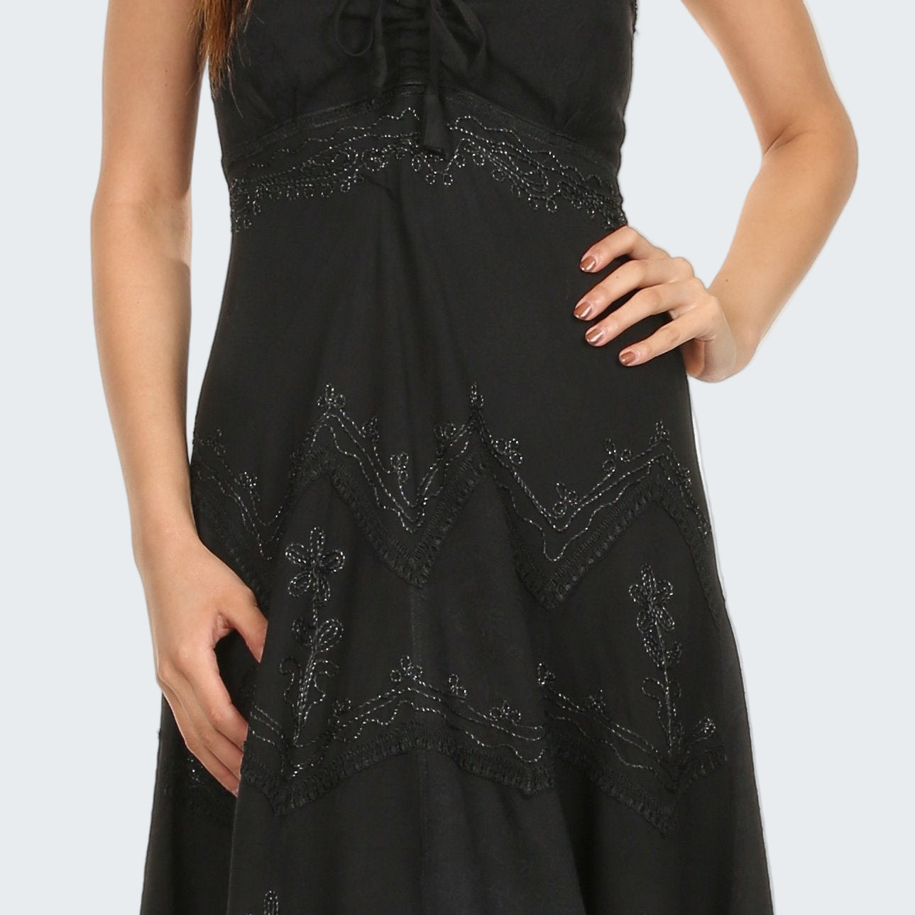 Black lace dress worn by a model on a white background