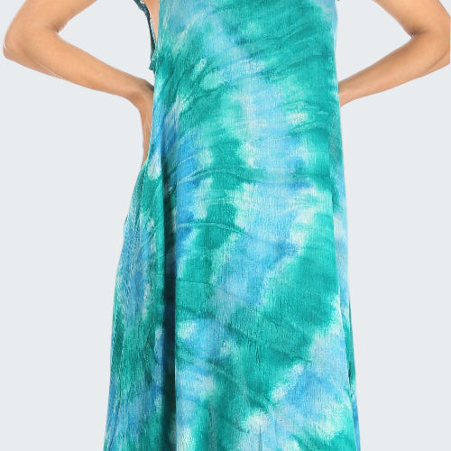 Woman wearing a teal and blue tie-dye dress with lace sleeves on a white background