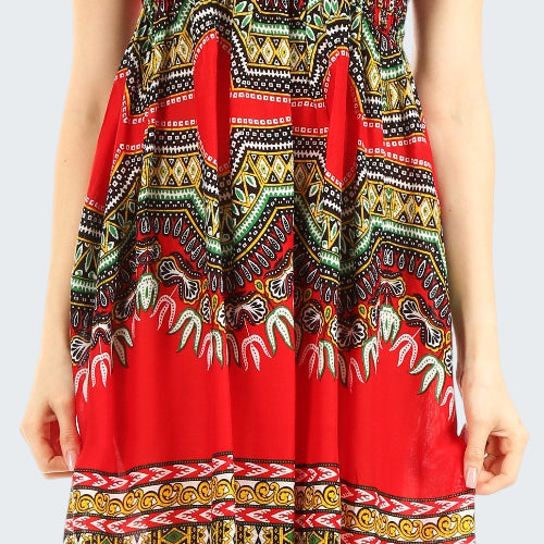 Red dress with colorful pattern worn by a person on a white background