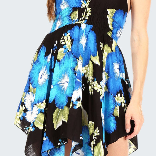 Woman wearing a blue floral dress with a black background
