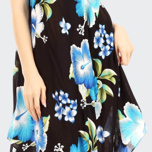 Woman wearing a black sleeveless dress with blue floral pattern