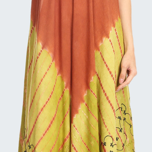 Woman wearing a rust and yellow dress with floral embroidery