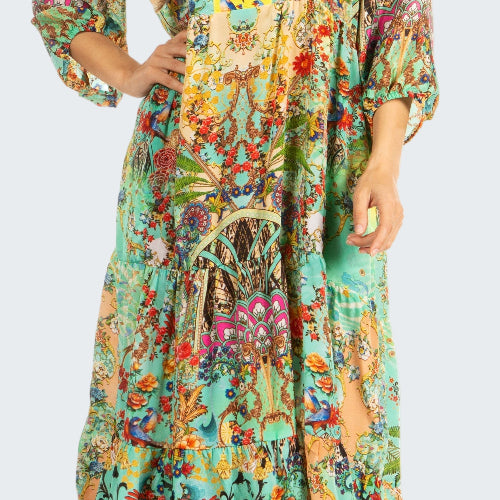 Woman wearing a colorful floral dress on a white background