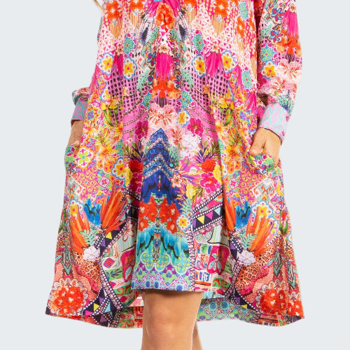 Woman wearing a colorful patterned dress on a white background