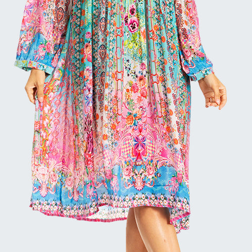 Woman wearing a colorful floral dress on a white background