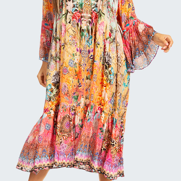 Woman wearing a colorful floral dress on a white background