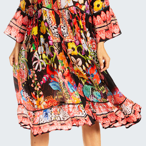 Woman wearing a colorful floral dress on a white background