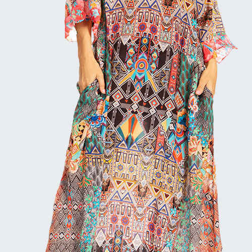 Colorful patterned dress worn by a model on a white background