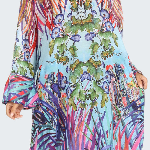 Colorful patterned dress with long sleeves on a white background