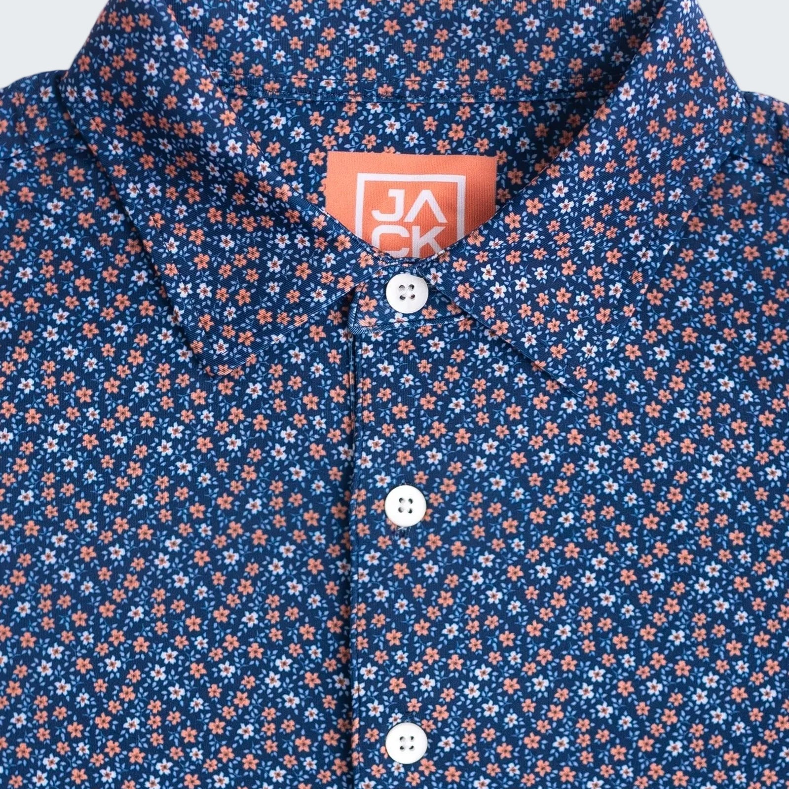 Close-up of a blue floral patterned shirt with a brand label.