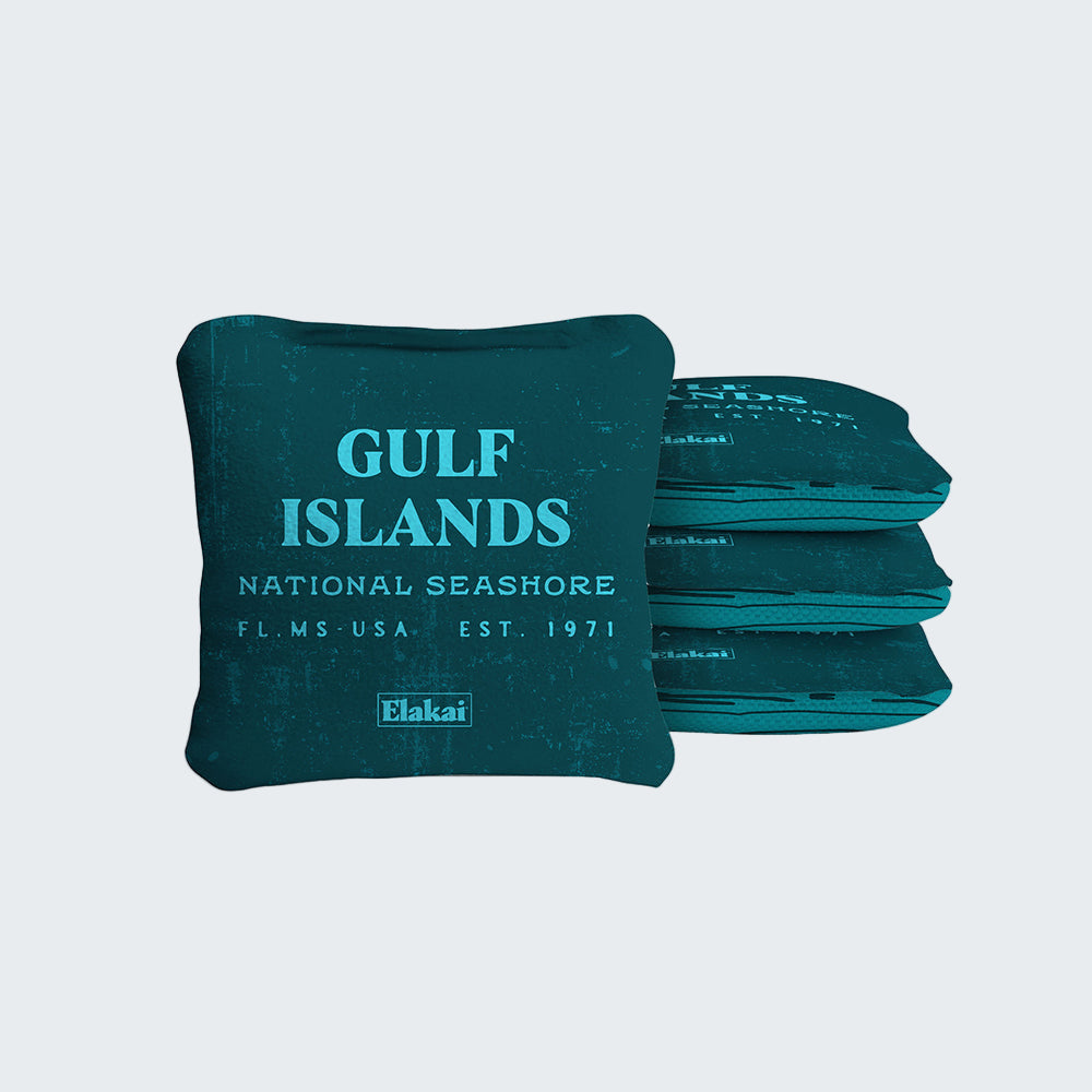 Teal bean bags with 'Gulf Islands National Seashore' text and Elakai branding on a white background