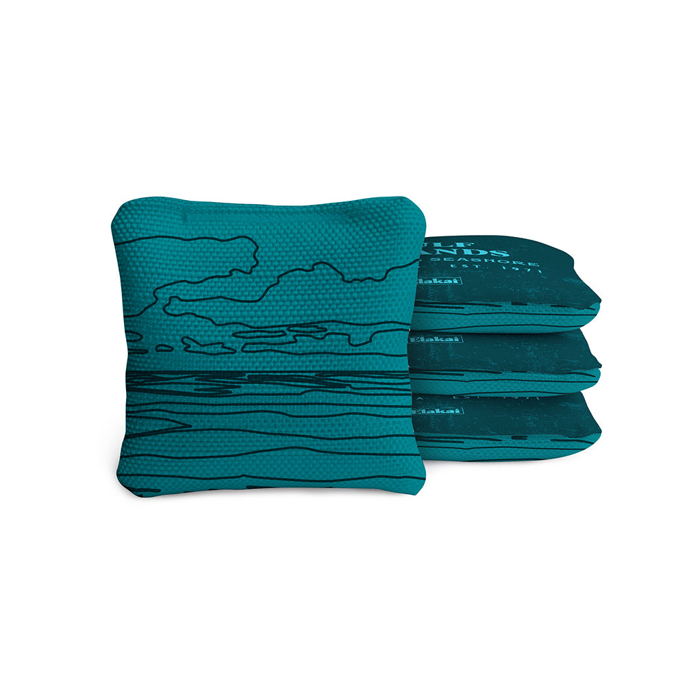 Stack of teal bags with a mountain design on a white background