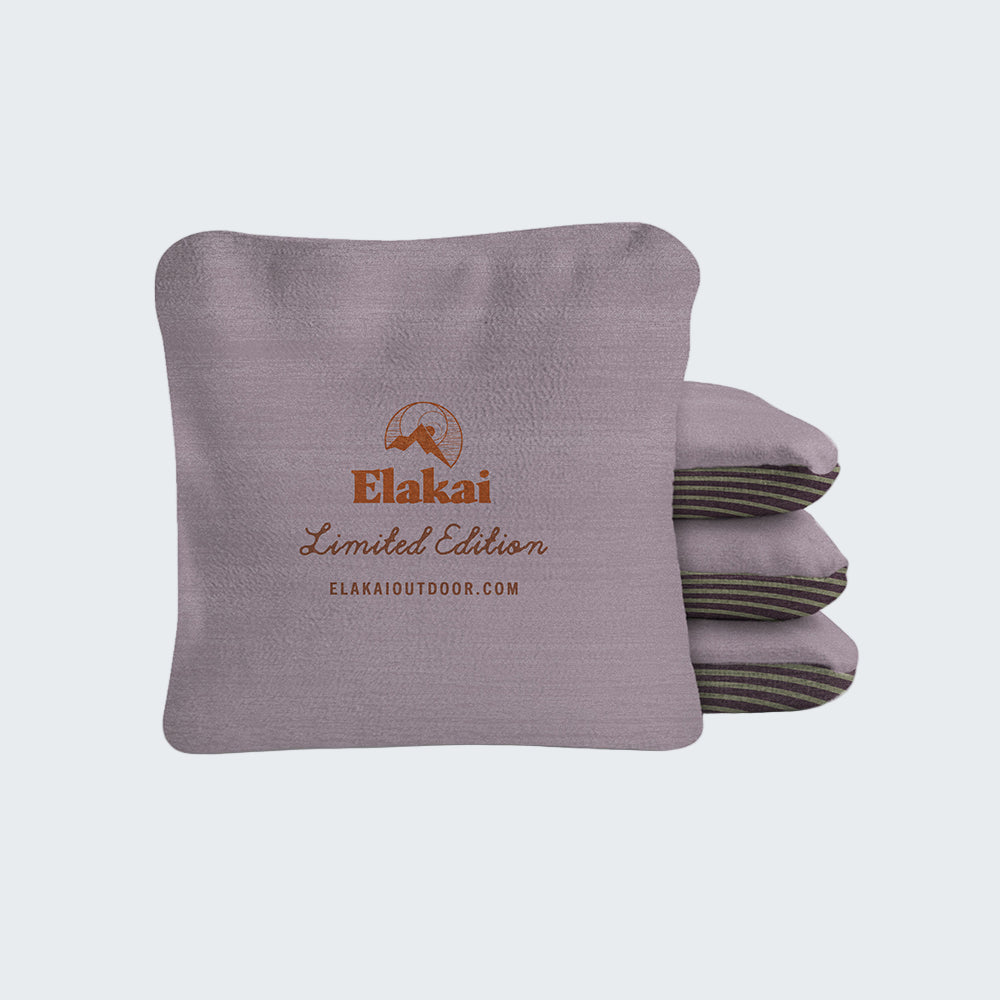 Gray folded blanket with Elakai branding on a white background
