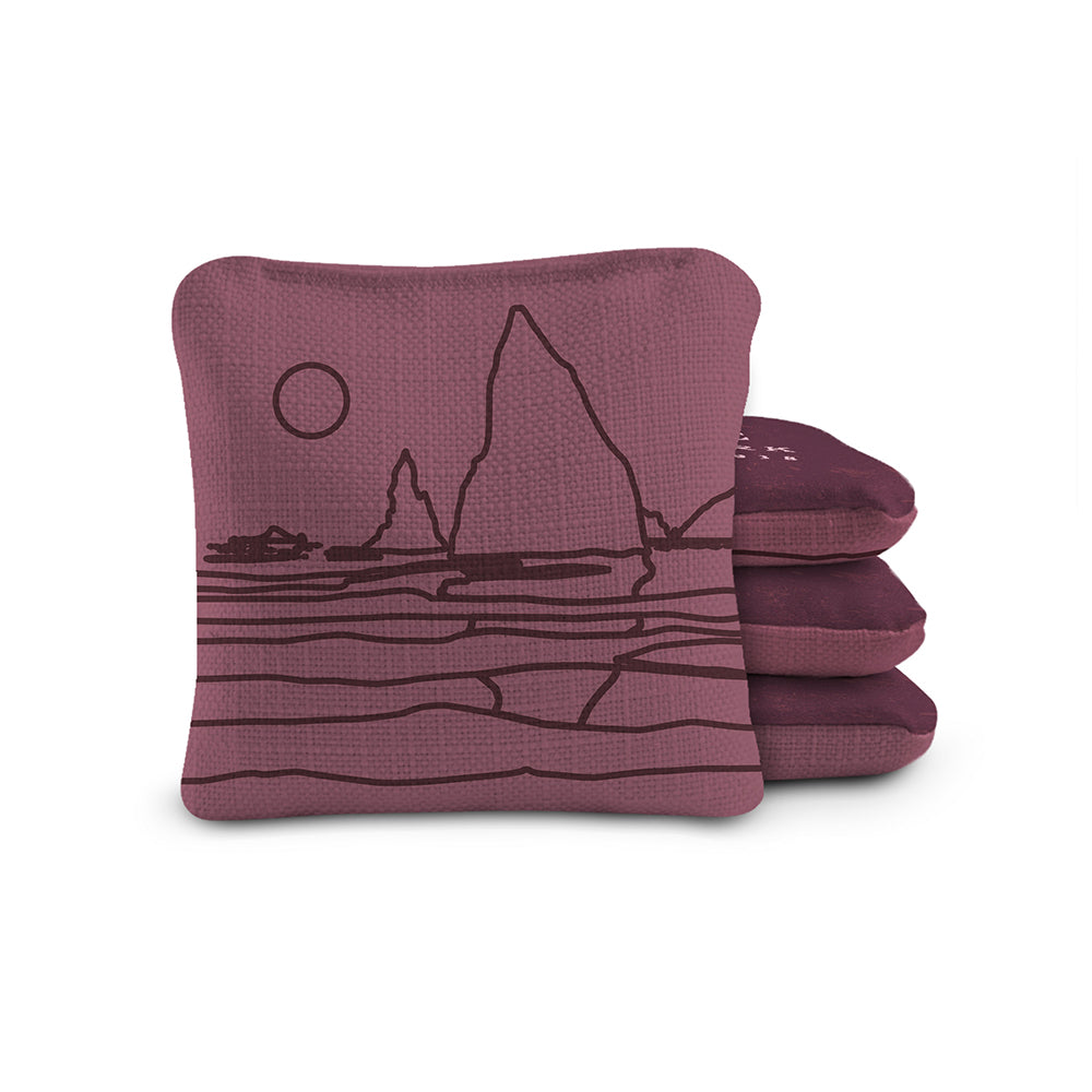 Purple cornhole bags with a black landscape design on a white background