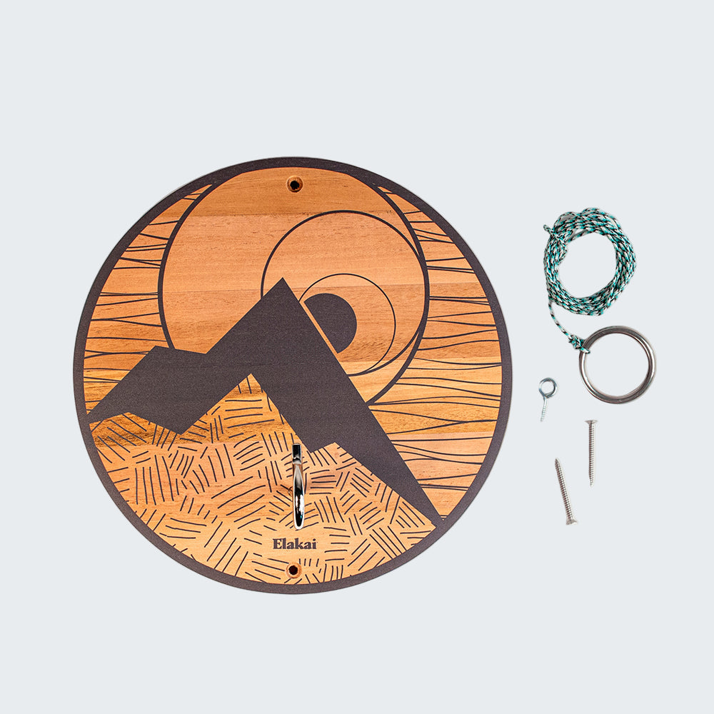Wooden disc with a mountain design and Elakali branding, accompanied by keys and a rope on a white background.