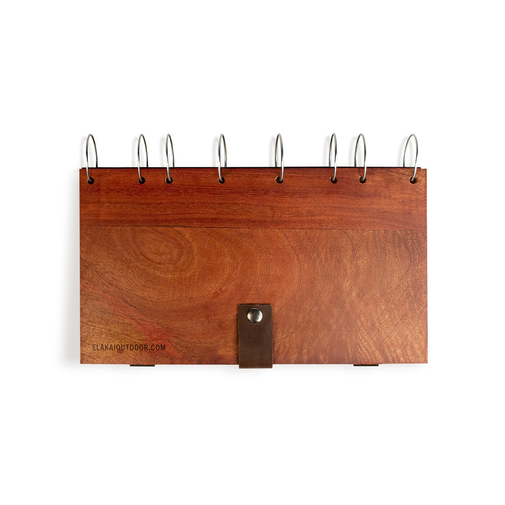 Wooden desk calendar with leather strap on a white background