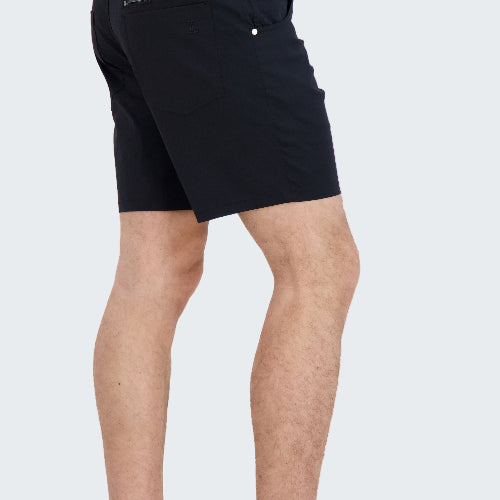 Person wearing black shorts with zippers on a white background