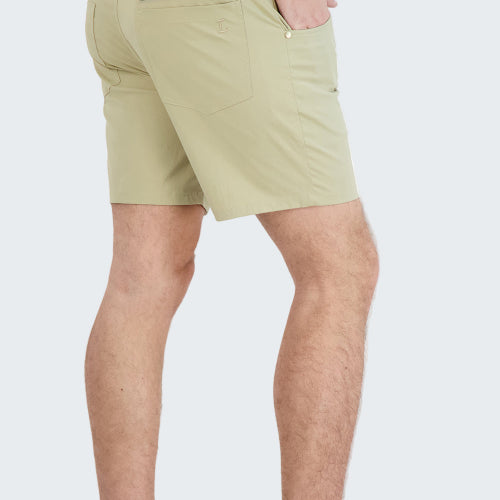 Beige shorts worn by a person on a white background