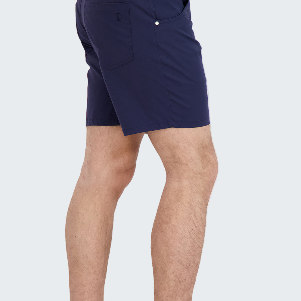 Person wearing navy shorts with a white background