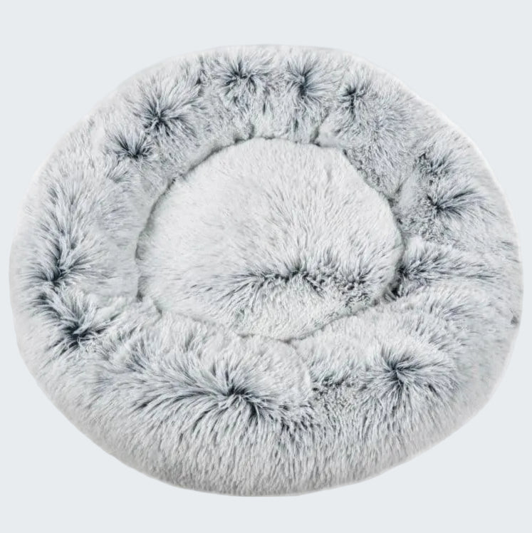 Round, fluffy pet bed on a white background