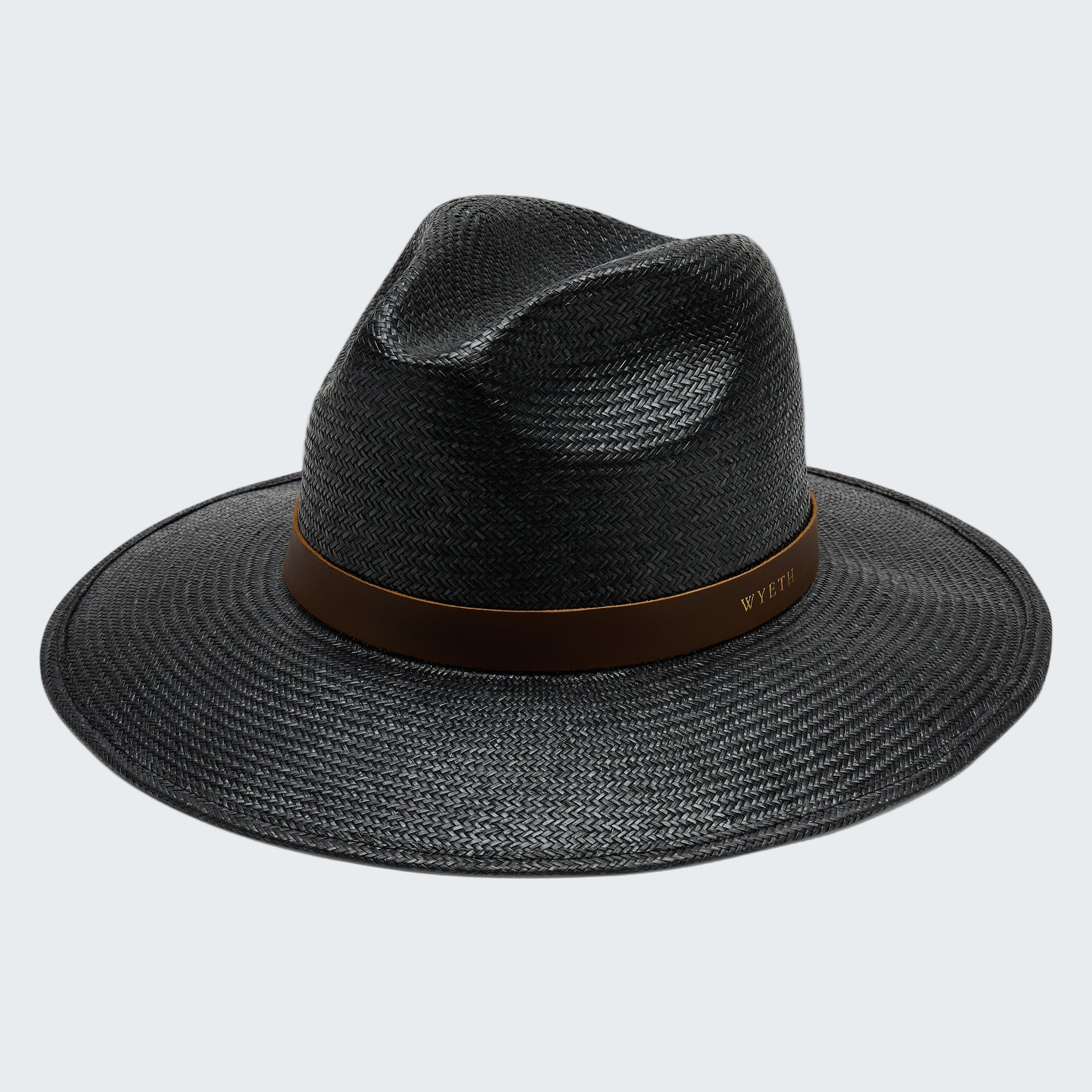 Black straw hat with a brown band on a white background