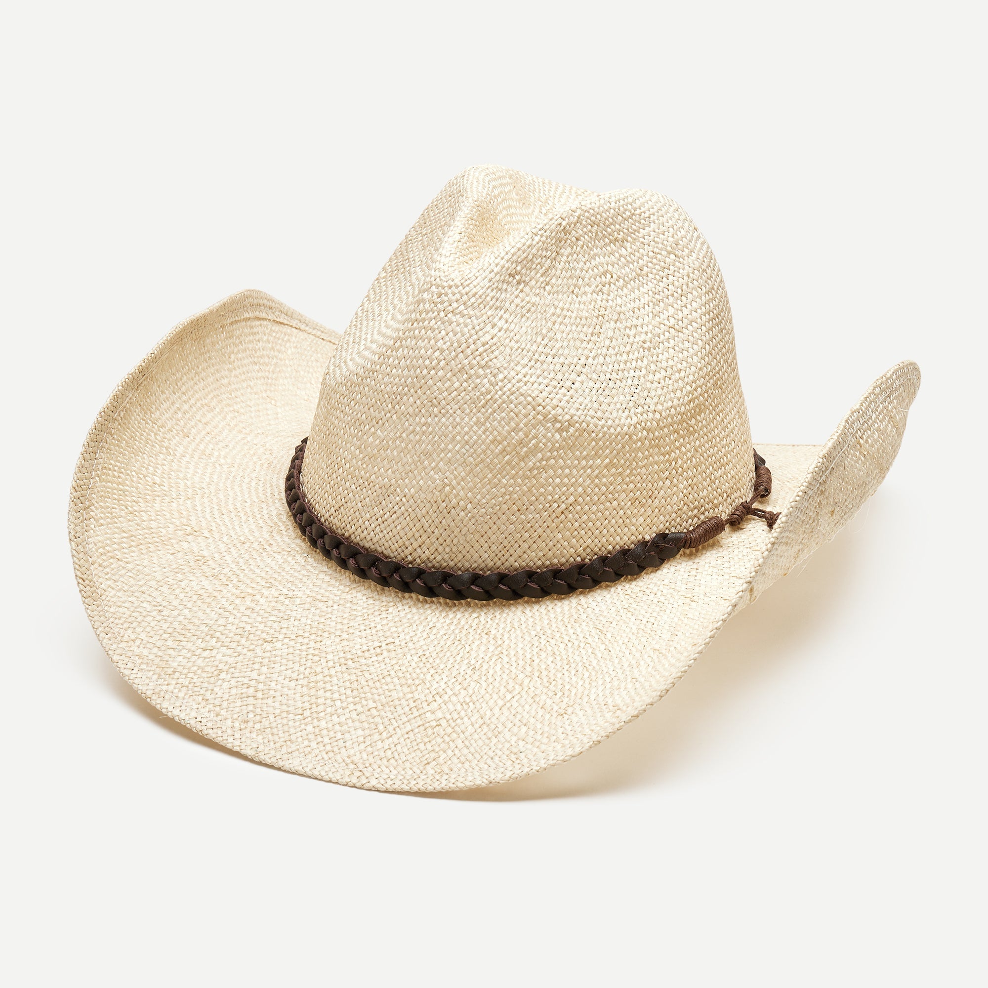 Beige straw cowboy hat with a braided brown band on a white background