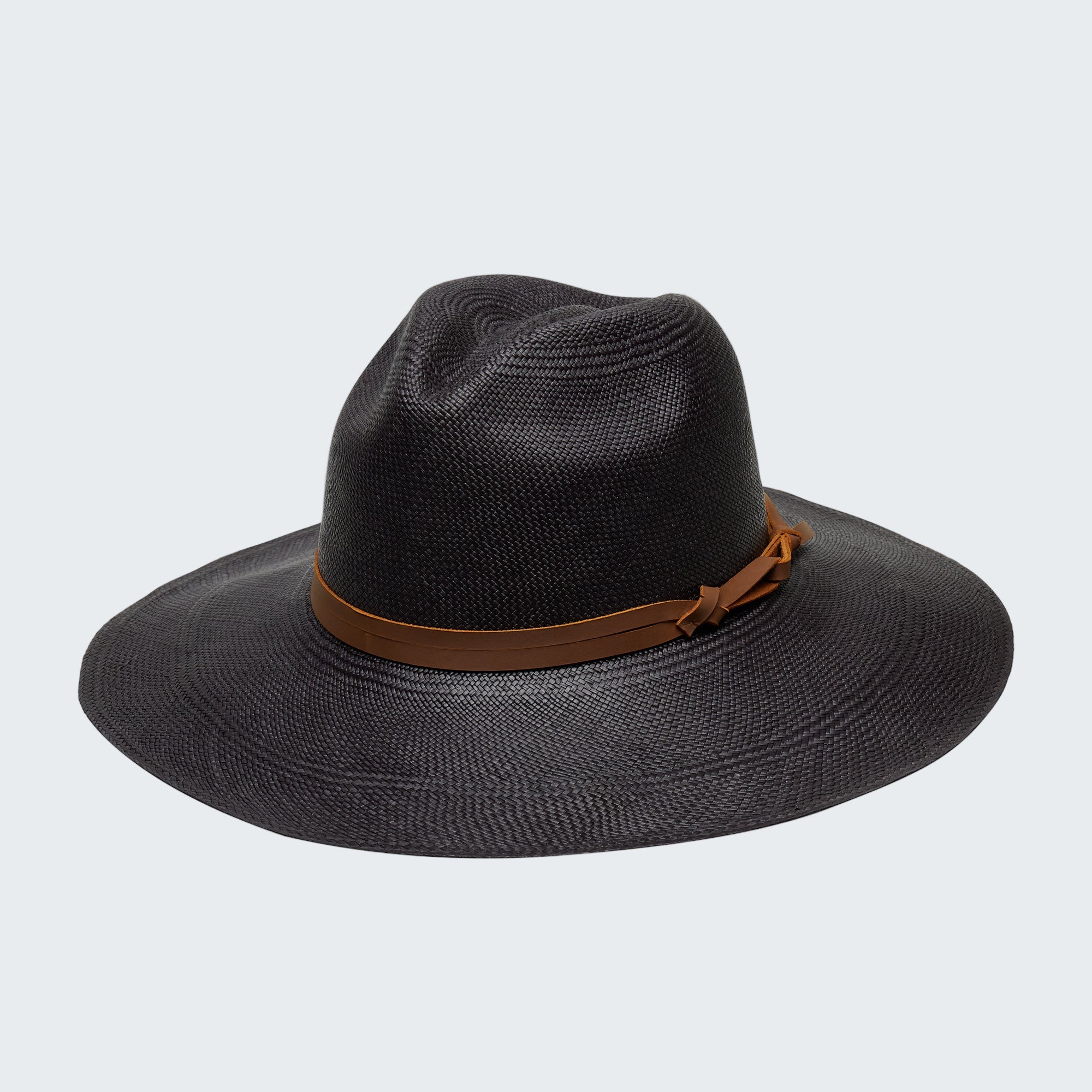 Black straw hat with a brown band on a white background
