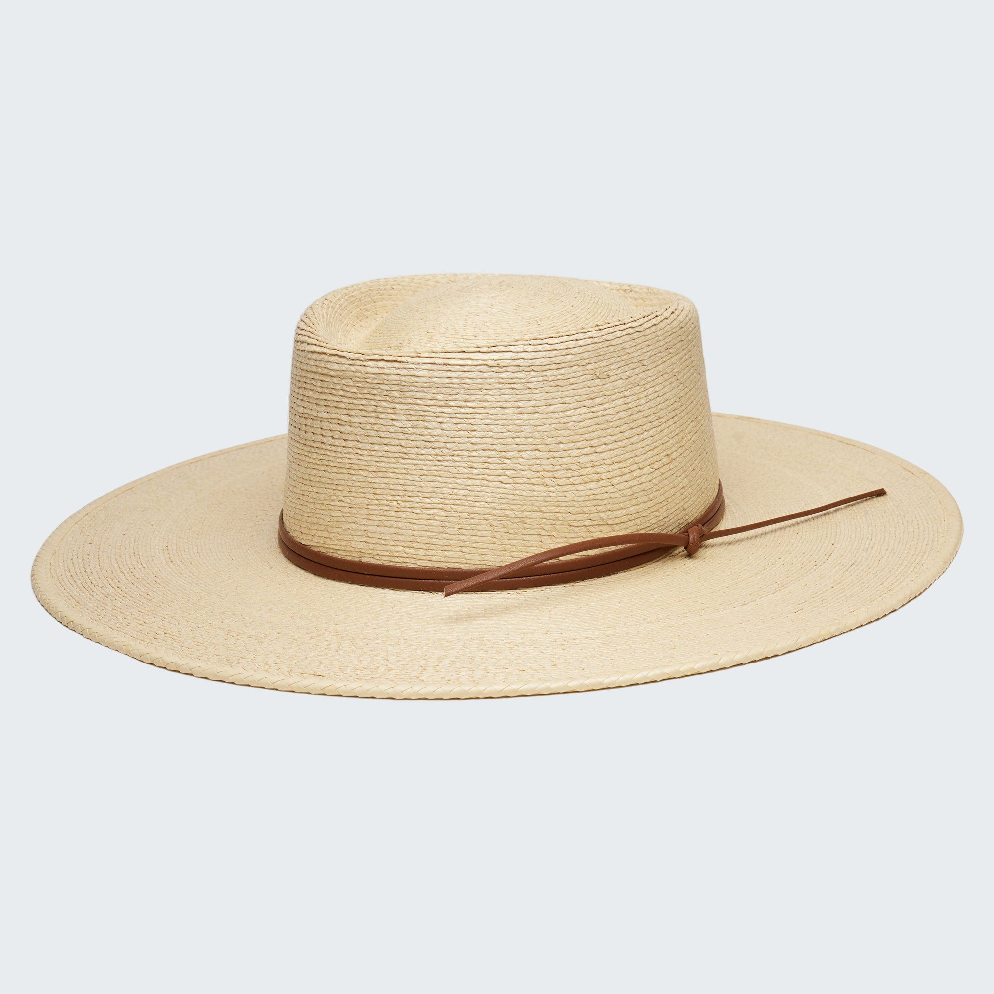 Beige straw hat with a brown band on a white background