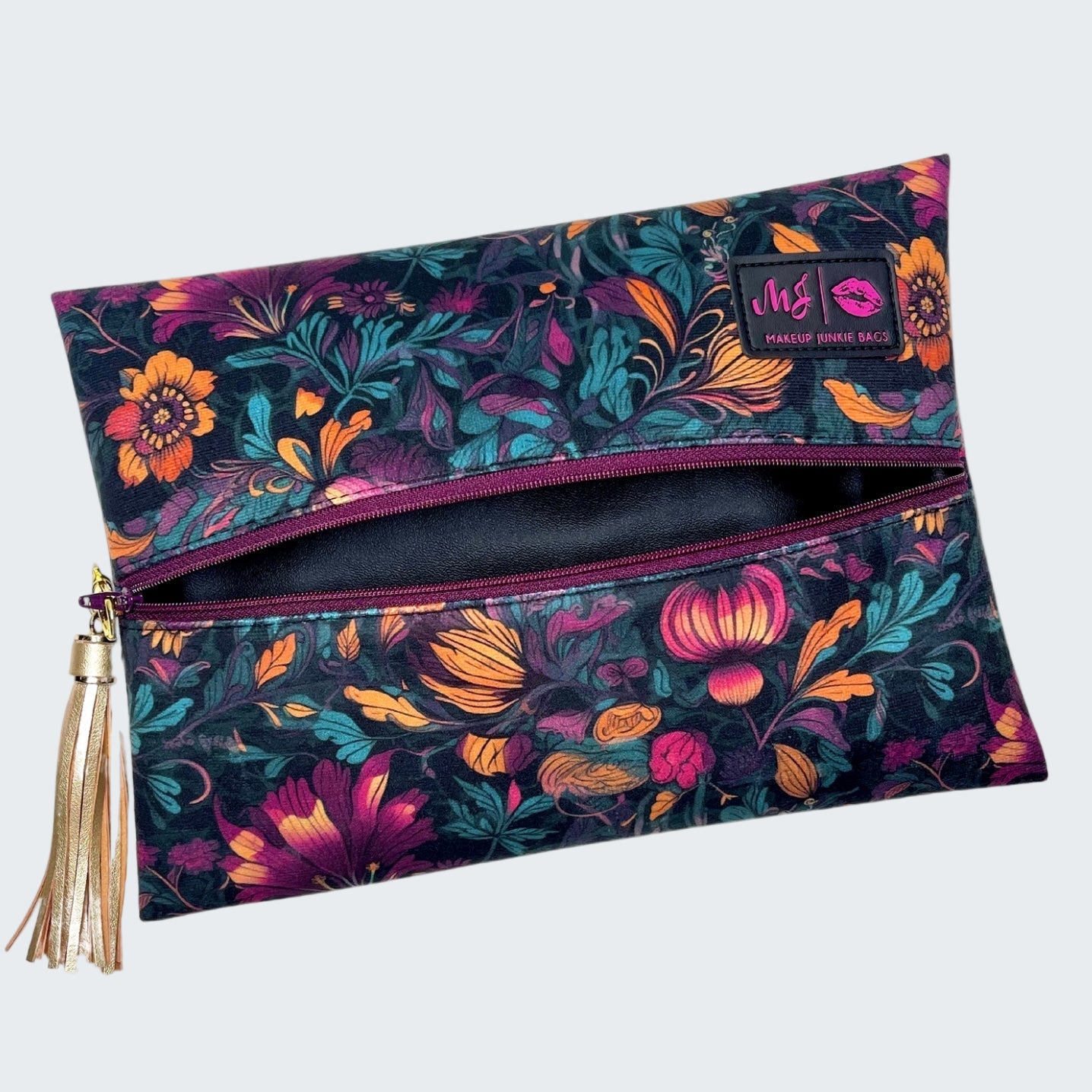 Floral patterned pouch with a tassel on a white background