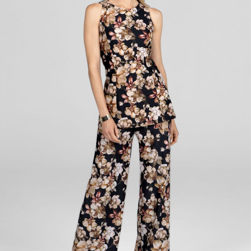 Woman wearing a floral jumpsuit on a white background