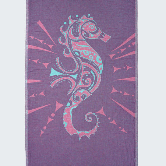 Purple towel with a colorful seahorse design on a white background
