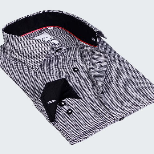 Folded black and white checkered dress shirt with a red interior on a white background