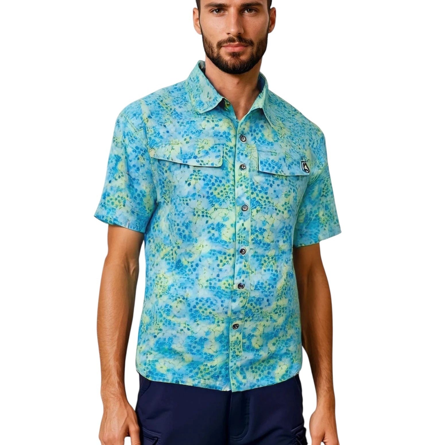 Man wearing a blue patterned shirt and navy pants on a white background
