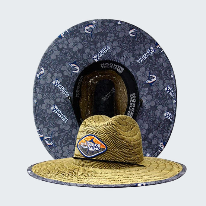 Yellow hat with a logo on a gray floral-patterned background