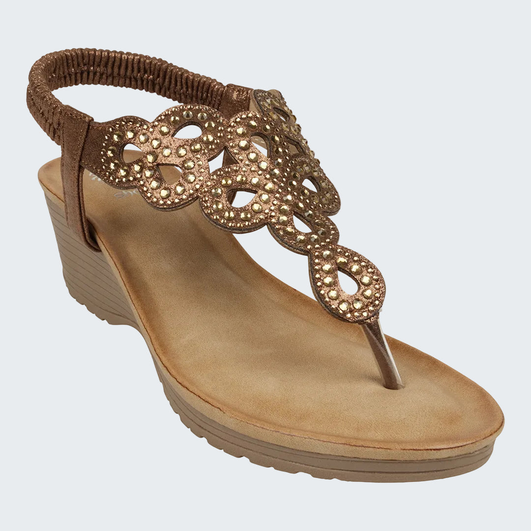 Brown sandal with decorative straps on a white background