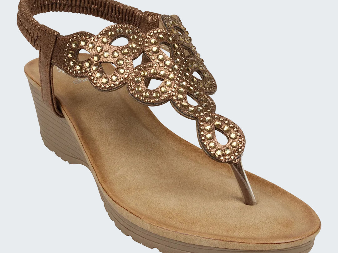 Brown sandal with decorative straps on a white background