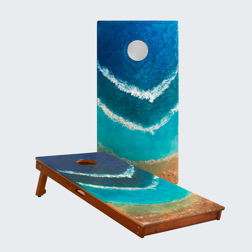 Cornhole board with ocean-themed design on a white background
