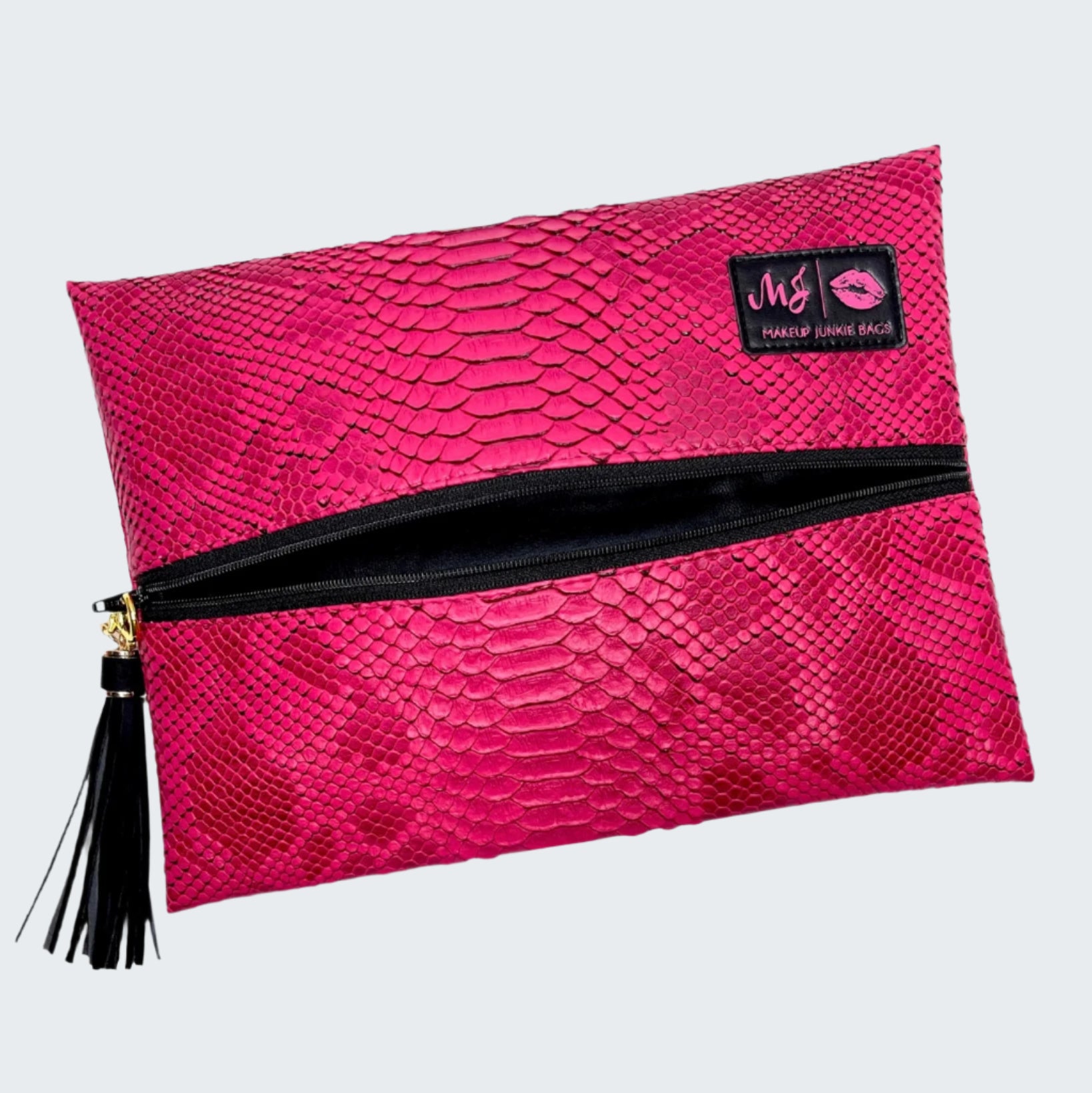 Pink textured makeup bag with black zipper and tassel on a white background