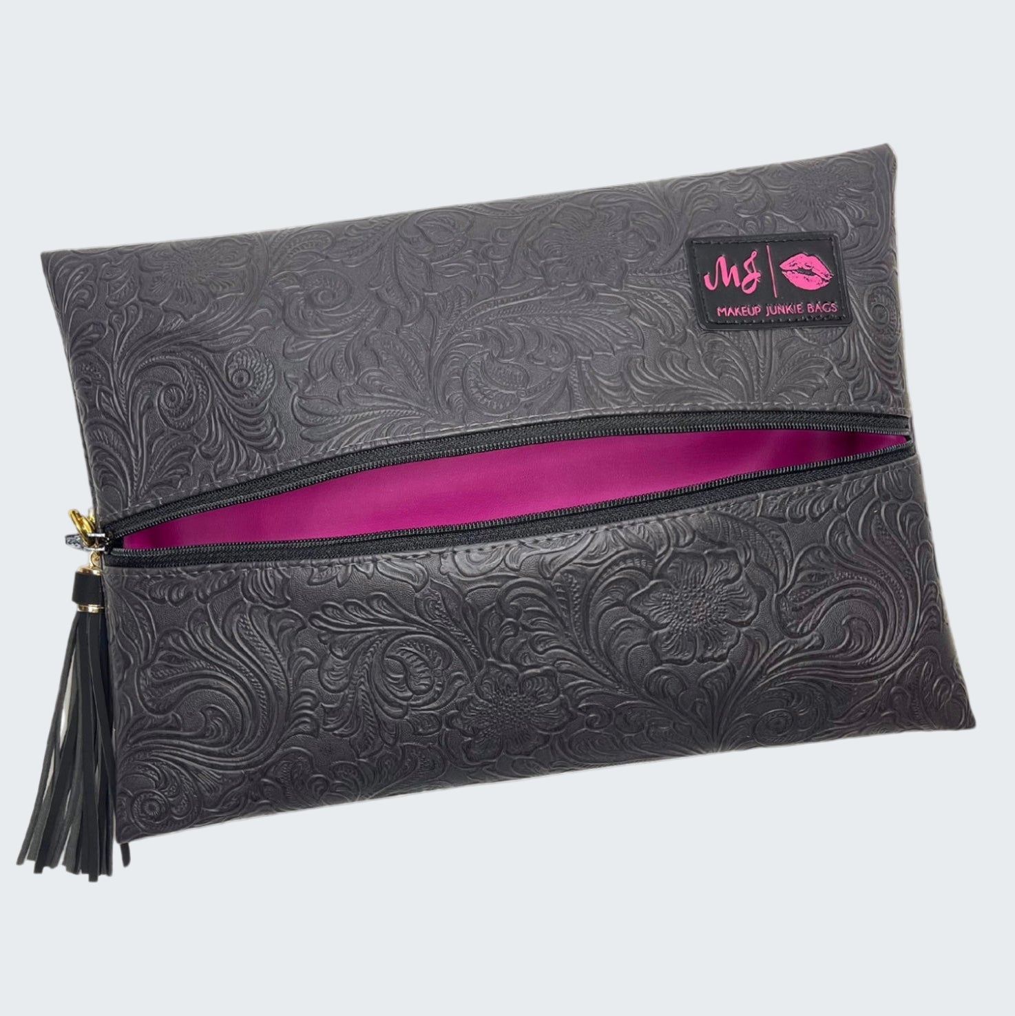 Black embossed clutch bag with a pink interior and visible brand logo on a white background