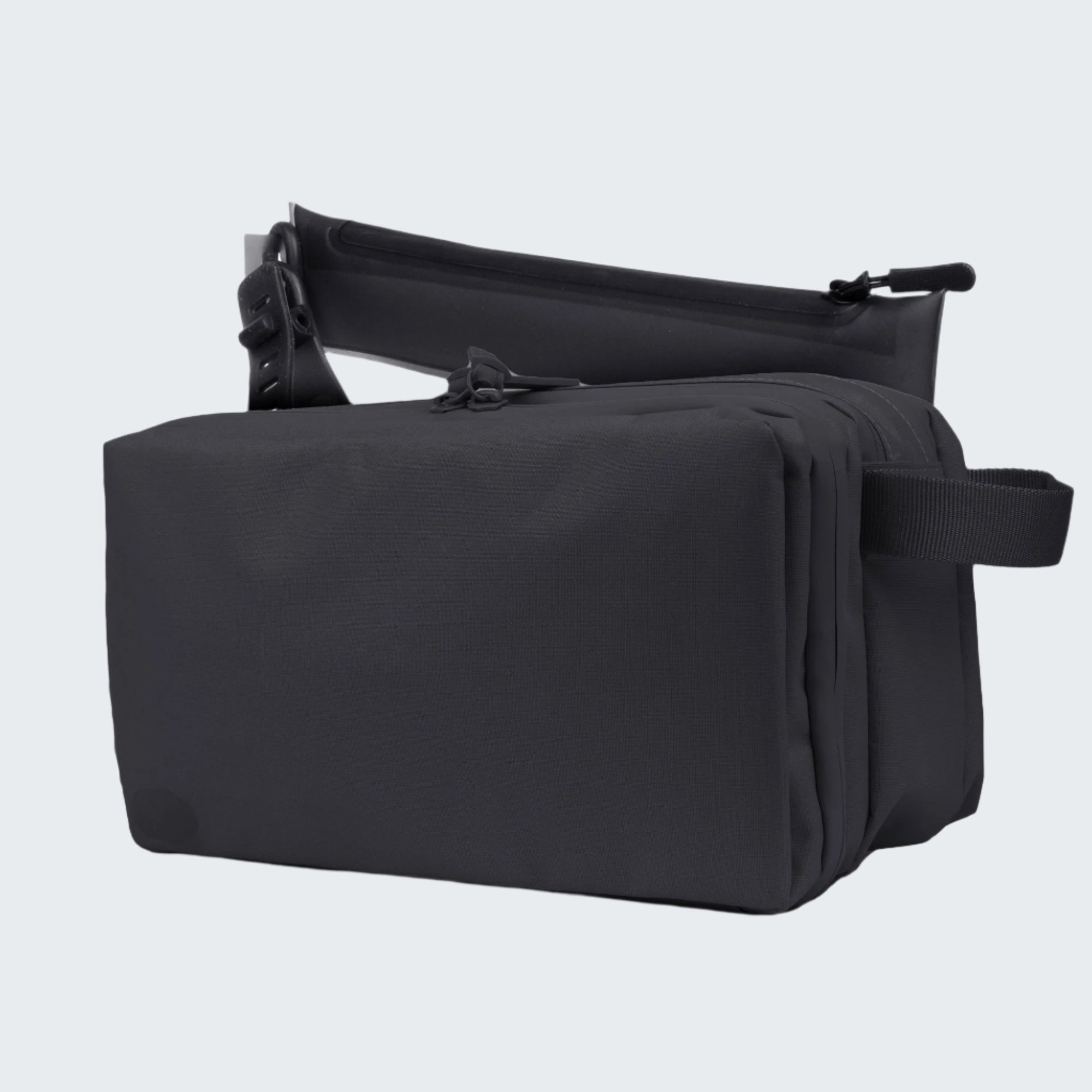 Black toiletry bag with a smaller black pouch on a white background