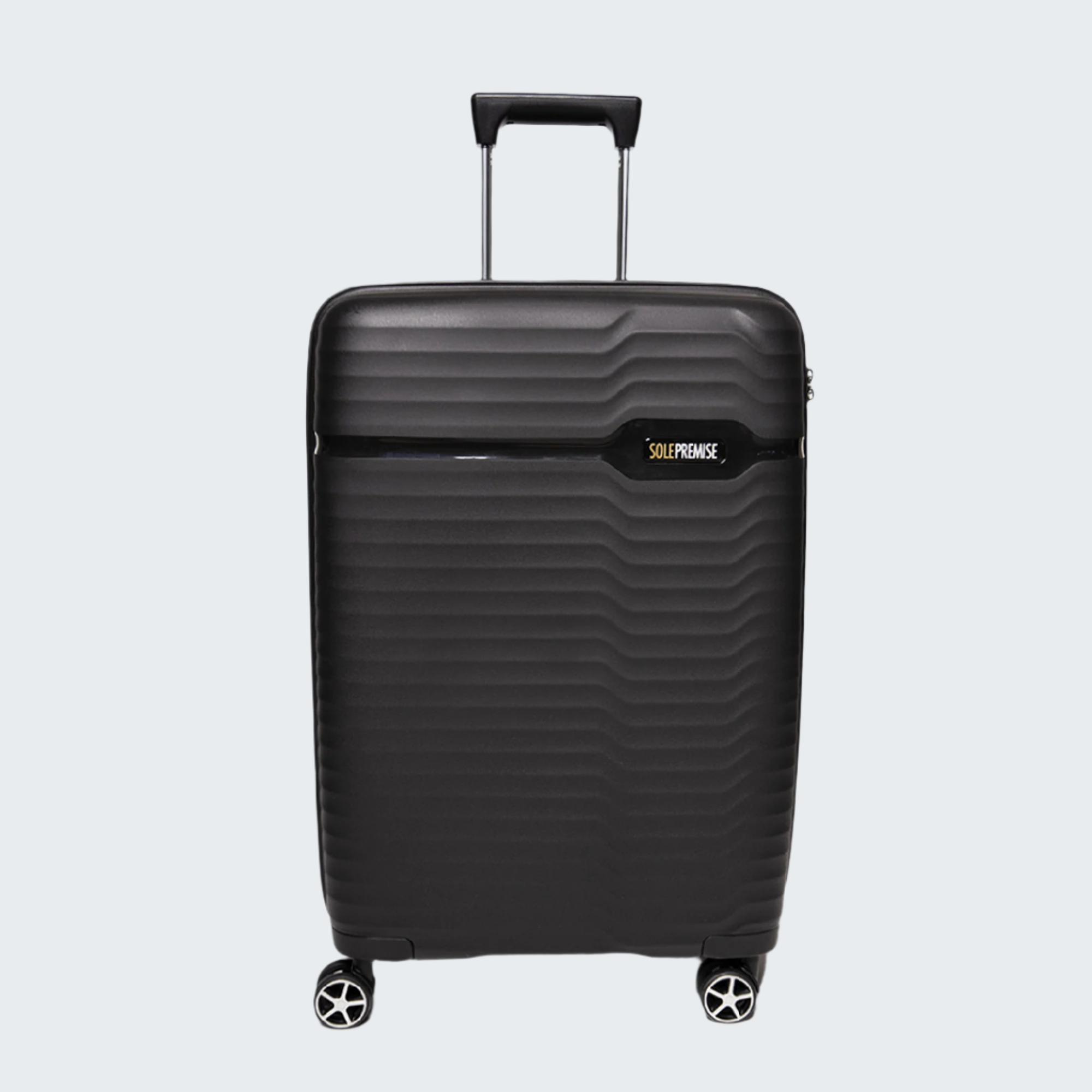 Black suitcase with a visible brand logo on a white background