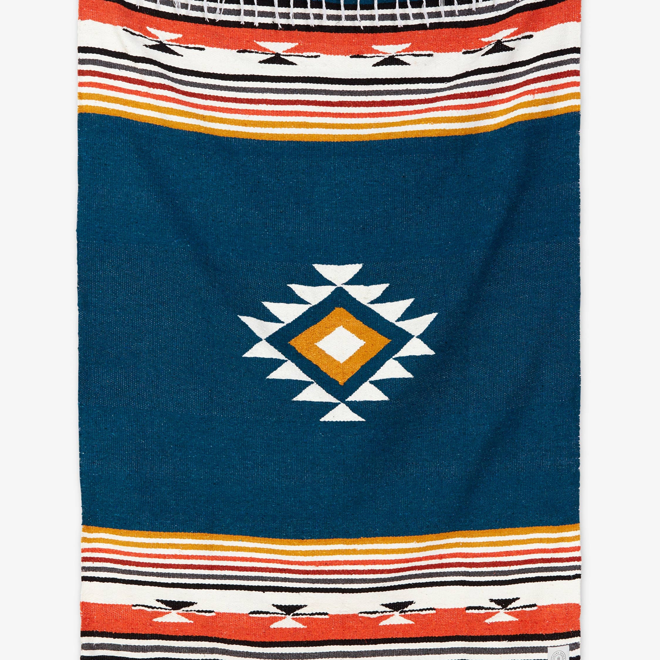 Navy blue blanket with geometric pattern and colorful stripes on a white background