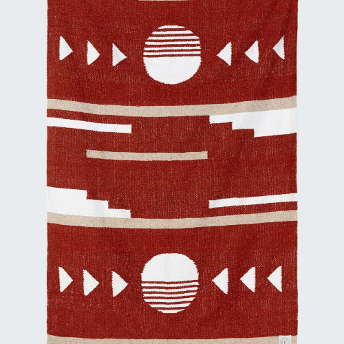 Red blanket with geometric patterns on a white background