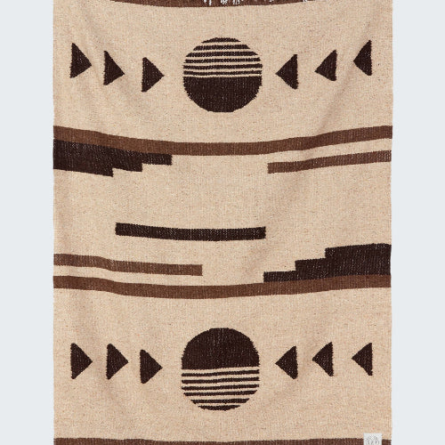 Beige blanket with black geometric patterns on a white background