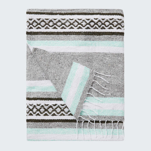 Gray blanket with black and white pattern and light blue accents on a white background