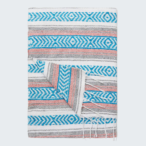 Patterned blanket with blue and pink design on a white background