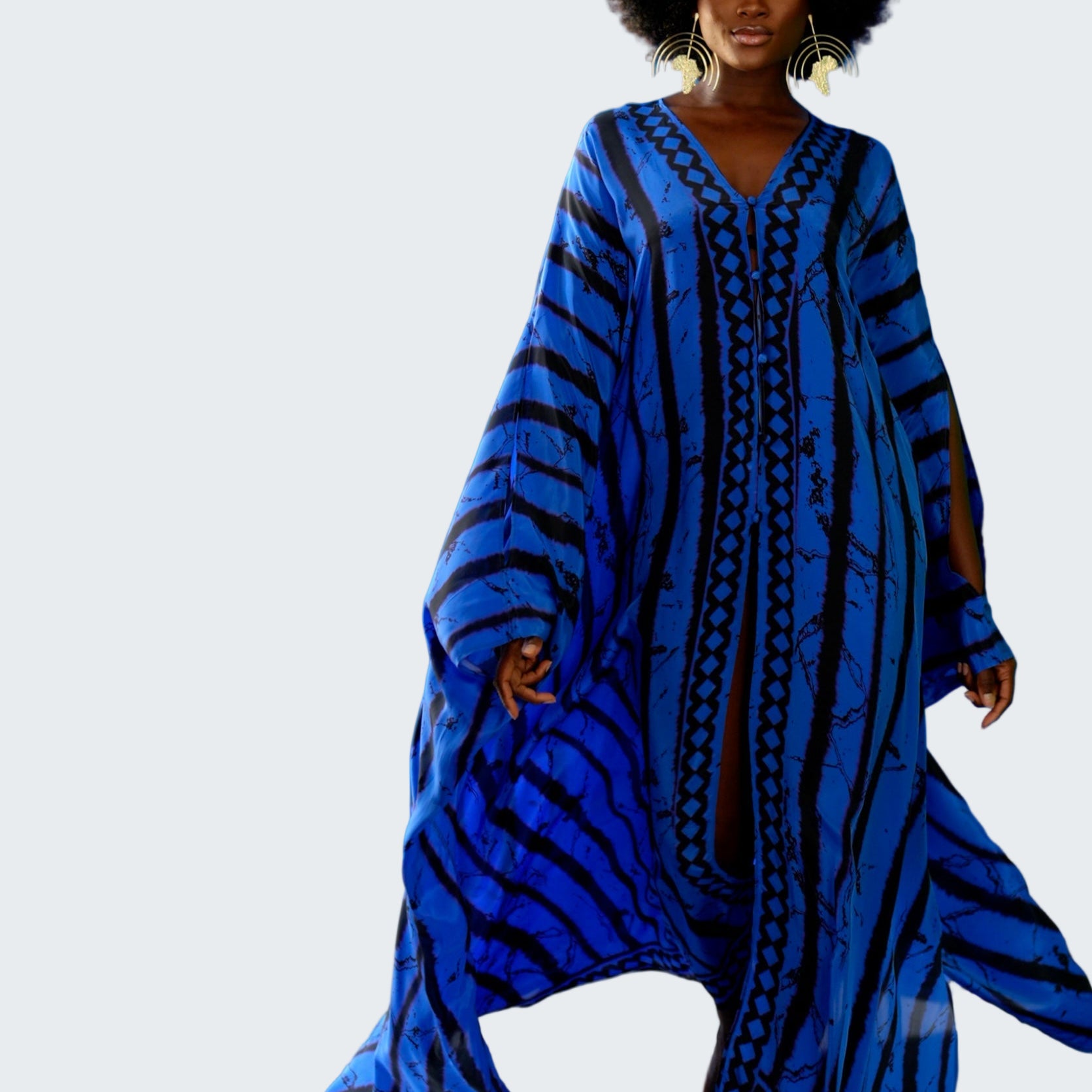 Woman wearing a blue patterned dress against a blue background